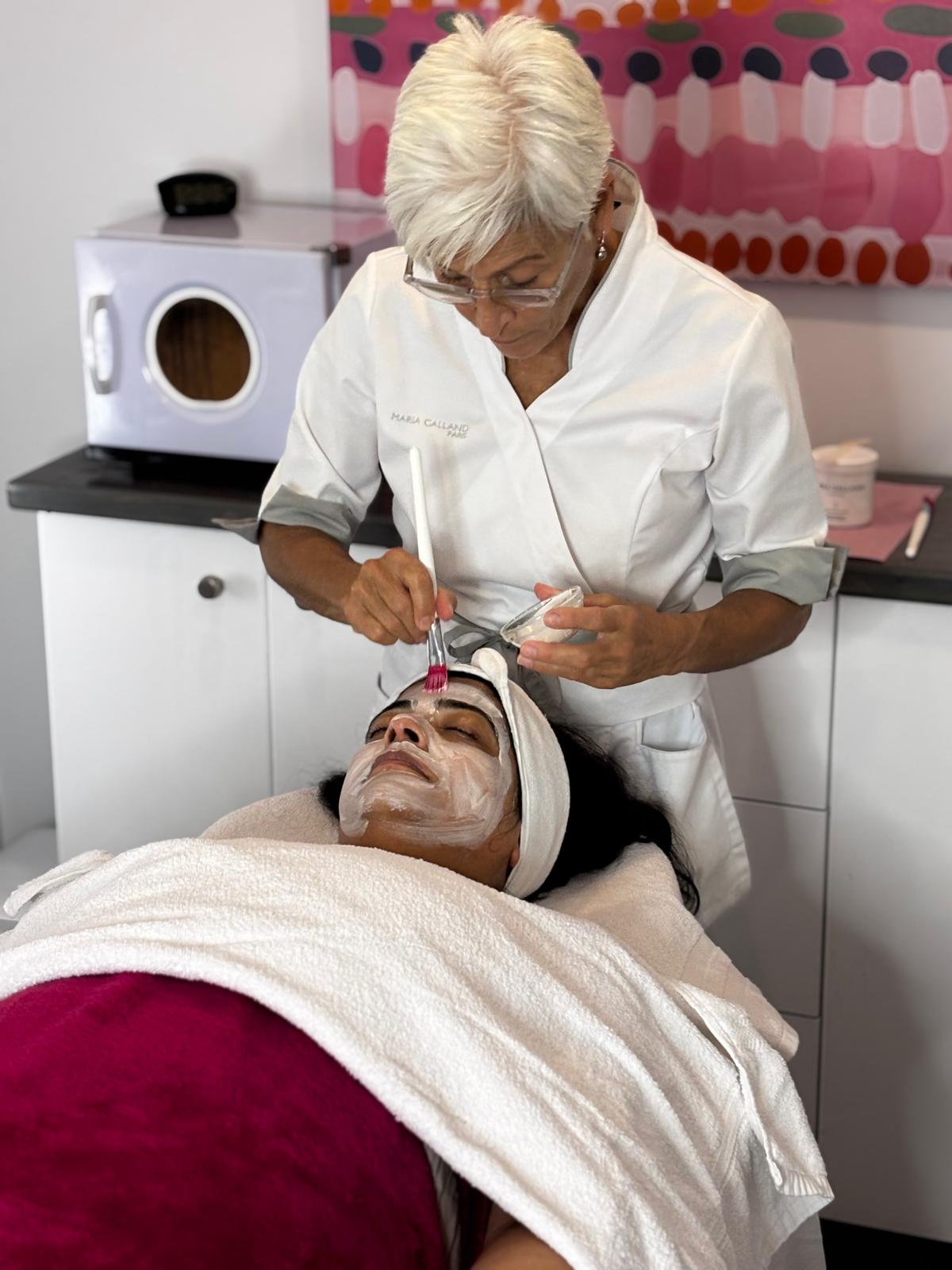 Esthetician applying serum